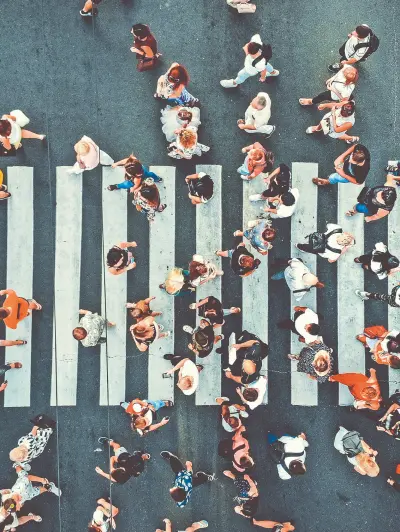 Aerial view of people crossing a pedestrian crosswalk