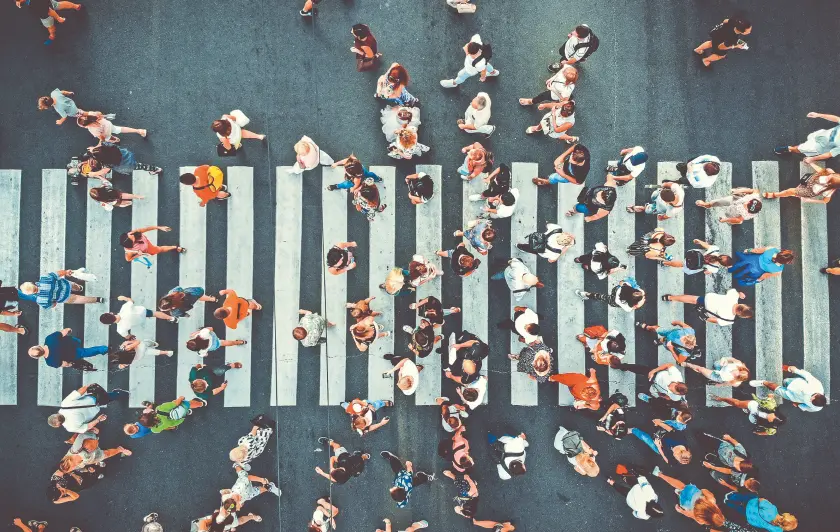 Aerial view of people crossing a pedestrian crosswalk