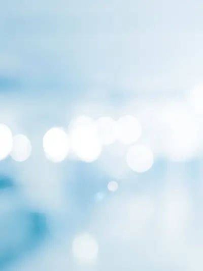 Abstract image with blurry white circles on a light blue background