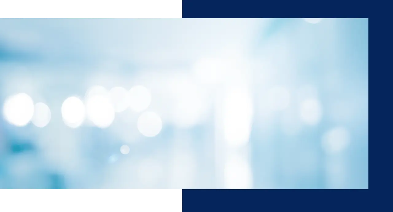 Abstract image with blurry white circles on a light blue background.