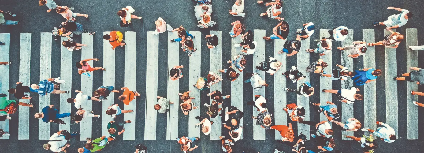 Aerial view of people crossing a pedestrian crosswalk