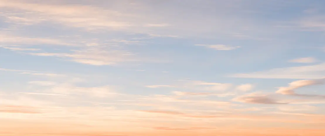 Pastel sunset sky with wispy clouds