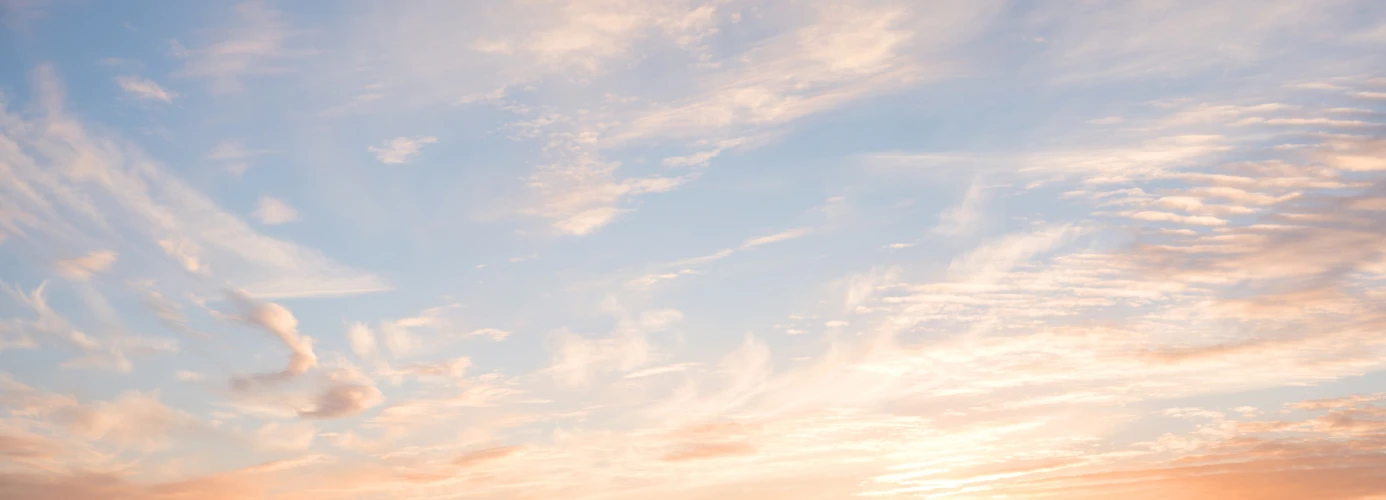 Pastel sunset sky with wispy clouds