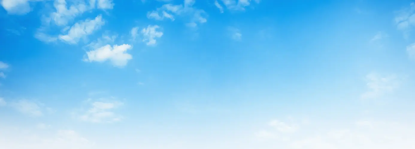Clear blue sky with wispy clouds