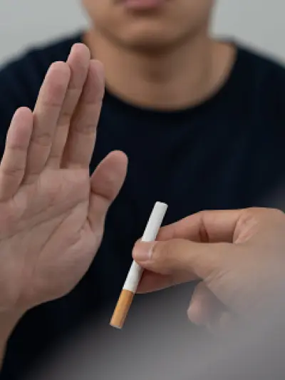 Hand gesturing to refuse a cigarette
