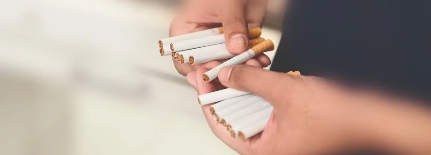 Hands holding multiple cigarettes