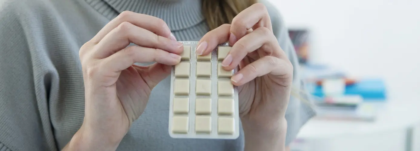 Hands holding a blister pack of medication