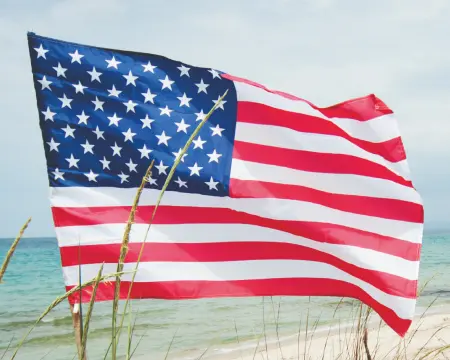 American flag waving on beach