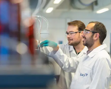 Scientists examining lab sample