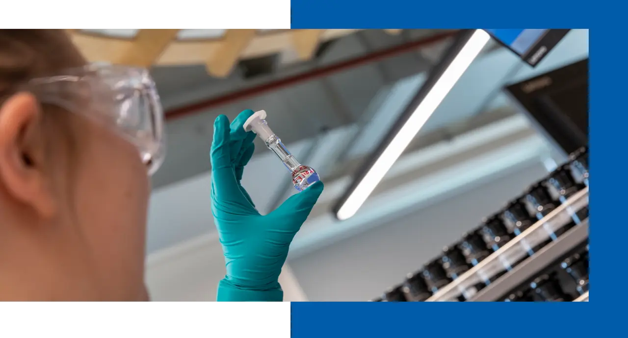 Scientist examining vial in lab