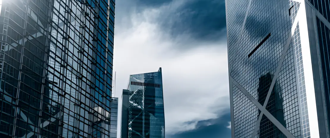 Modern glass skyscrapers against a cloudy sky in Hong Kong