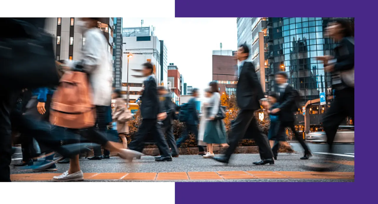 Blurred image of people walking on a busy city street in Japan.