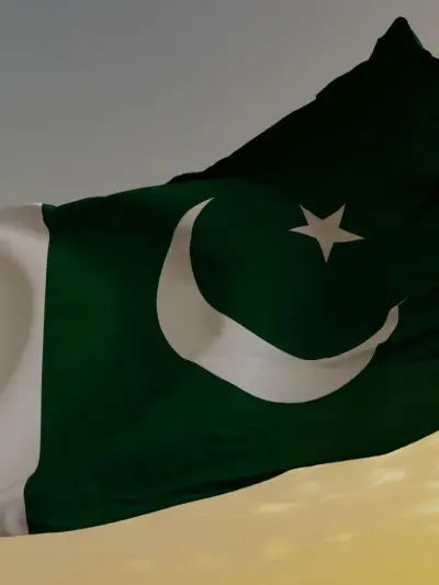 Close-up of the Pakistani flag, showing its green field with a white crescent moon and star.