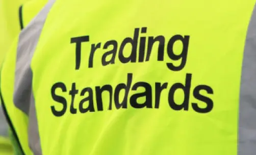 High-visibility vest with "Trading Standards" text