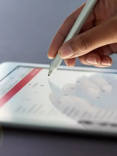 Hand using stylus on tablet
